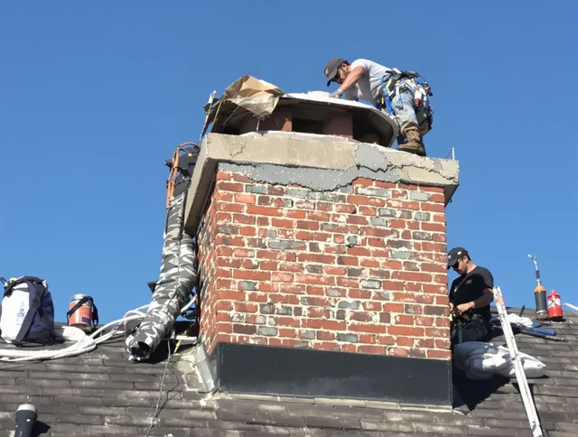 Costa Mesa Chimney Sweep installing a custom chimney crown in Costa Mesa, CA