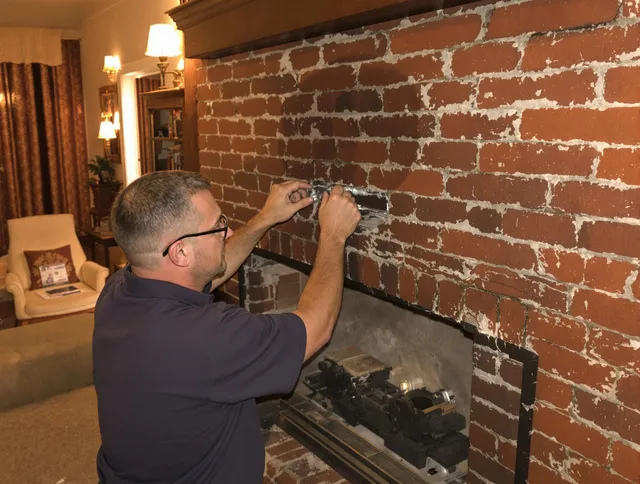 Costa Mesa Chimney Sweep expert fixing a fireplace in Costa Mesa, CA